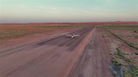 Preparing for flight and take-off, a private plane standing among the soft golden sands of the desert, air travel, transportation lines and tourist trips, traveling around the world