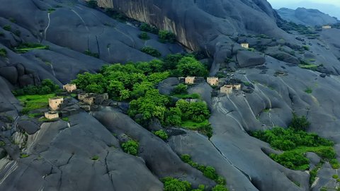 Ghayeh village in Al-Majardah Governorate in Asir, Saudi Arabia, green trees and plants, smooth rocks, rocky mountains, Asir landmarks, mountainous terrain, tourism in Saudi Arabia