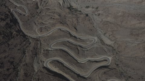 The mountainous environment in the Kingdom of Saudi Arabia, aerial drone photography of winding roads in the city of Al-Baha, rock formations, peaks and heights in historical landmarks, a famous tourist place and landmark, attracting tourists from all over the world.