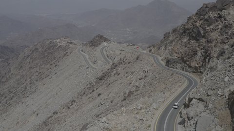 Mountains, rock formations, peaks and heights in historical landmarks, a famous tourist place and landmark, attracting tourists from all over the world, the mountainous environment in the Kingdom of Saudi Arabia, aerial drone photography of winding roads in the city of Al Baha