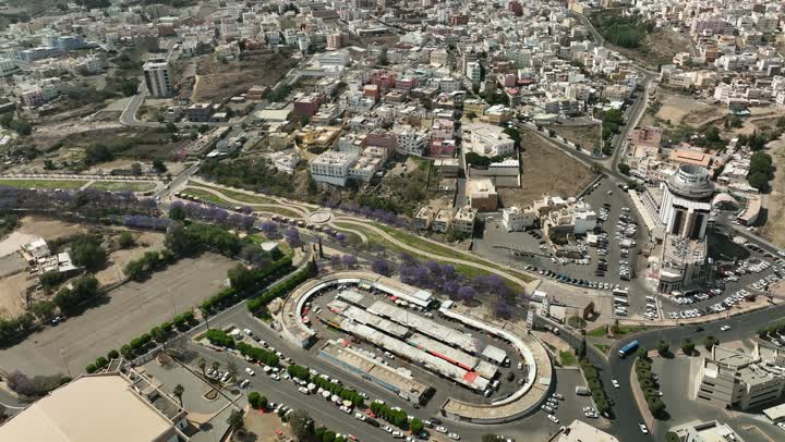 Neighborhoods and residential houses in the city of Abha in the Kingdom of Saudi Arabia, car traffic on asphalt streets, paved roads and streets, trees and green plants