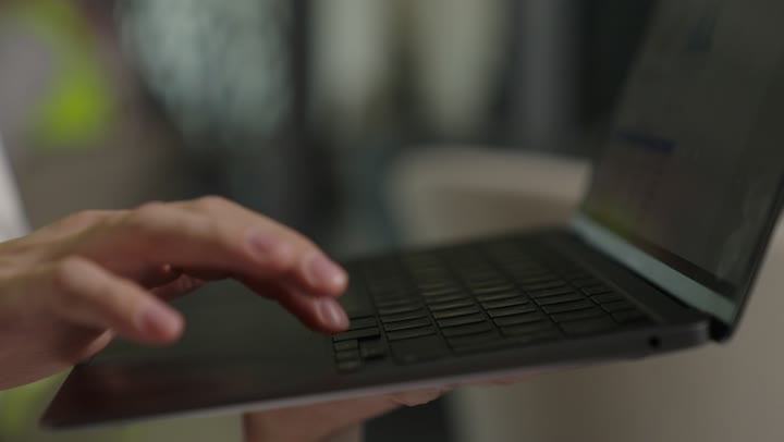 Remote business management, using modern and advanced devices, an employee completing required tasks via laptop, a Saudi Gulf Arab woman wearing an abaya and hijab using a laptop, integrating technology into work, women's professions and jobs.