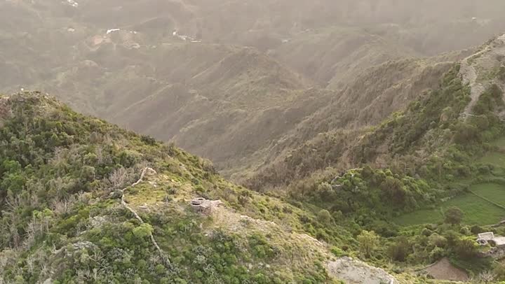 The beauty of stunning nature, tourism in Saudi Arabia. Aerial photography of the sunrise over the Tolan Mountains, golden rays embracing the peaks.
