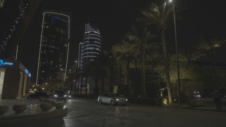 The Kingdom Tower building in Riyadh at night, the architectural engineering art of building towers and skyscrapers in a modern style, famous landmarks and tourist places in the Kingdom of Saudi Arabia.