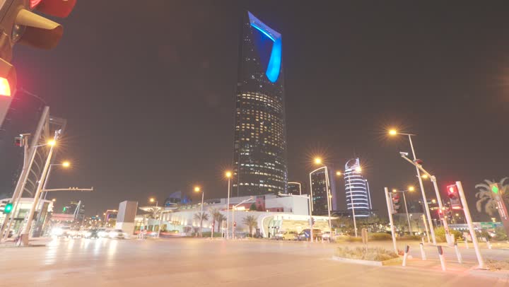 The Kingdom Tower building in Riyadh at night, the architectural engineering art of building towers and skyscrapers in a modern style, famous landmarks and tourist places in the Kingdom of Saudi Arabia.