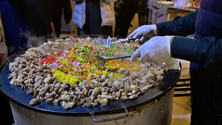 Preparing food on the griddle, cooking a variety of different Saudi dishes and beverages, close-up shots of a Gulf Arab Saudi chef preparing food for serving.