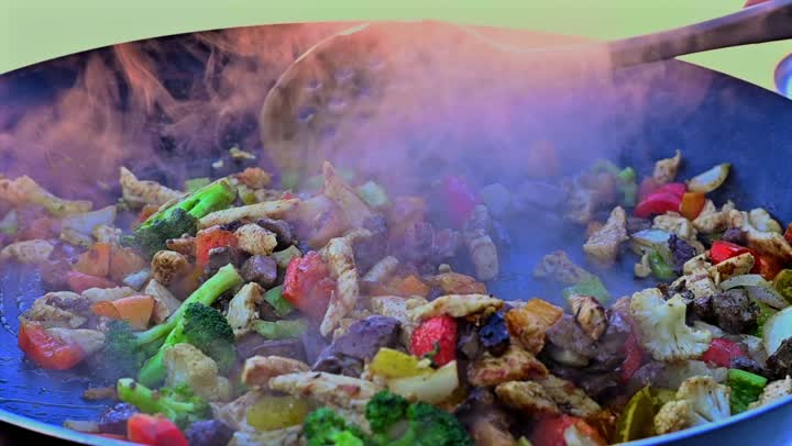 Preparing food on the griddle, cooking a variety of different Saudi dishes and beverages, close-up shots of a Gulf Arab Saudi chef preparing food for serving.