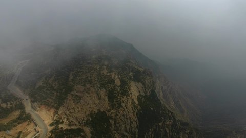 Foggy, cloudy skies in highlands, famous natural landmarks, topography of mountain peaks and heights, aerial drone footage of Tanuma Mountains in Saudi Arabia