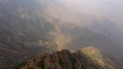 Foggy and cloudy weather in the highlands, famous natural landmarks, terrain in the mountain peaks and heights, aerial drone photography of Sha'af Al Waleed in Namas, Saudi Arabia