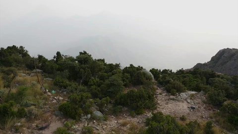 Foggy and cloudy weather in the highlands, famous natural landmarks, terrain in the mountain peaks and heights, aerial drone photography of Sha'af Al Waleed in Namas, Saudi Arabia