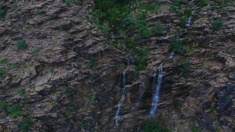 Waterfalls on the mountain slopes and slopes, afforestation and green plants, agricultural terraces in Wadi Kahla in the Al-Rabou’a region in Asir, famous landmarks and tourist places, distinctive natural landscapes in the Kingdom of Saudi Arabia