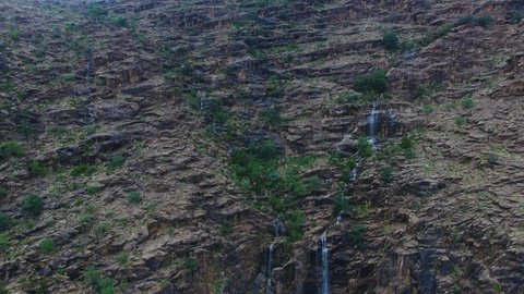 Waterfalls on the mountain slopes and slopes, afforestation and green plants, agricultural terraces in Wadi Kahla in the Al-Rabou’a region in Asir, famous landmarks and tourist places, distinctive natural landscapes in the Kingdom of Saudi Arabia