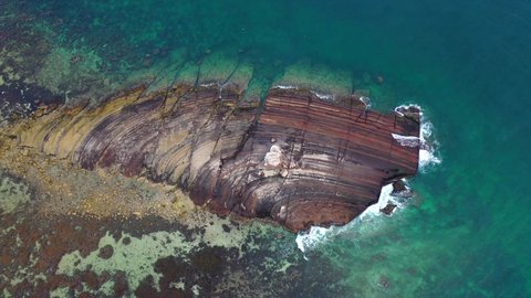 Tourist attractions in the Kingdom of Saudi Arabia, aerial drone photography of Jabal Kadmbel Island in Asir, calm sea waves on the Red Sea coast, mountain peaks and heights during the day