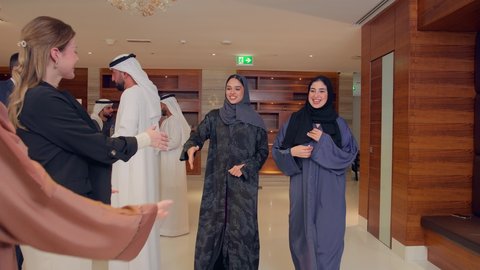 Receiving foreign delegations, concluding new business deals, agreeing on commercial projects, a meeting of a team of Arab Gulf Emiratis with a foreign delegation in a luxurious conference hall, discussion and exchange of ideas among businessmen, a business exhibition in the United Arab Emirates with representatives.