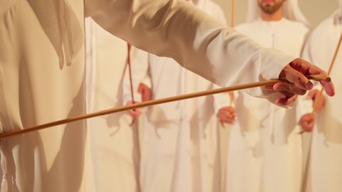 Traditional folk dance, celebrating the national holiday with the dance of the khayrzan is part of the traditional attire of the Emirates, folk dances during national occasions, festivals, and holidays, close-up of the popular dance of Al Ayala, wearing traditional attire at a national event, folklore performance troupe.