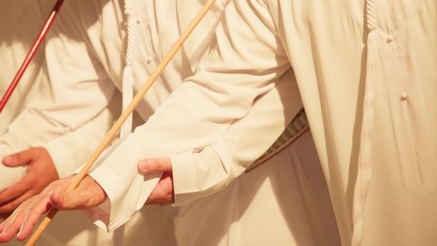 The chants and folk dances, celebrating the national holiday with the dance of the khaziran is part of the traditional attire of the Emirates, folk dances during national occasions, festivals, and holidays, a close-up shot of the folk dance Al Ayala, wearing traditional attire at a national event, a troupe of heritage folklore performances.