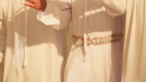 Gestures of prestige and preserving traditions, celebrating the national holiday with the traditional dance of Al-Khuzan is part of the traditional attire of the Emirates, folk dances during national occasions, festivals, and holidays, close-up shots of the folk dance Al-Yawla, wearing traditional attire at a national event, a folklore heritage performance troupe.