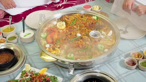 A table filled with various types of food, delicious healthy recipes, the art of presenting delicious Emirati Eastern dishes, traditional Arab foods and dishes, a popular rice dish with spiced meat prepared in the Emirati kitchen.