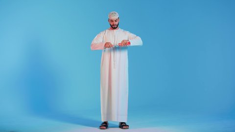 تجنب تسوس الاسنان وامراض اللثة ، بورتريه لرجل عربي خليجي اماراتي  يقوم بتنظيف الأسنان بفرشاة الأسنان ، مفهوم العناية والإهتمام بصحة ونظافة الأسنان ، روتين نظافة الفم اليومية ، خلفية ملونة