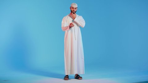 بورتريه لرجل عربي خليجي اماراتي  يقوم بتنظيف الأسنان بفرشاة الأسنان ، مفهوم العناية والإهتمام بصحة ونظافة الأسنان ، روتين نظافة الفم اليومية ، تجنب تسوس الاسنان وامراض اللثة ، خلفية ملونة