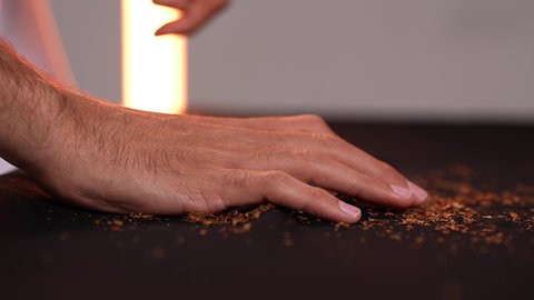 Drug use and harmful chemical substances, stopping harmful behavioral habits, fighting the smoking habit, a close-up shot of a young Emirati Gulf Arab man wearing a kandura destroying cigarettes, gestures indicating caution against addiction.