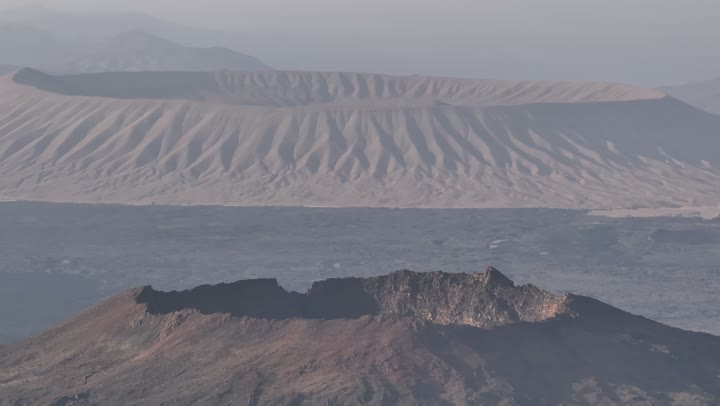 The mountains and volcanic craters in the Khaybar Lava Field, the landmarks of Medina, the natural volcanic fields, a destination for tourists and earth scientists, natural places in the Kingdom of Saudi Arabia.