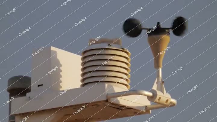 The weather vane of the weather station rotates in the wind