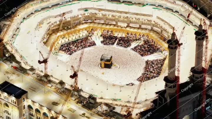 Night aerial view of the Kaaba surrounded by pilgrims in the Grand Mosque