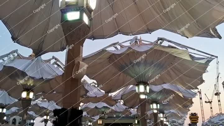 Automatic sun shade umbrellas of Medina Haram Piazza in the morning