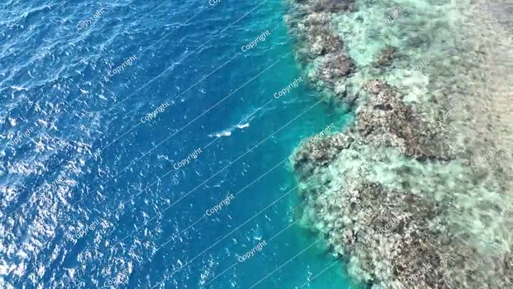 Aerial view drone flying over blue sea. Beautiful sea waves and coral reef water