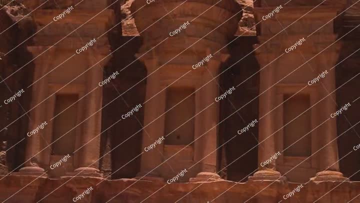 Close-up detail of the intricately carved sandstone facade at the ancient city