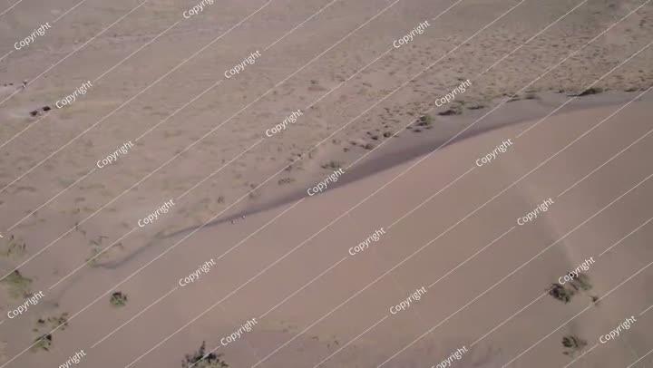 A large sand dune in the middle of the desert