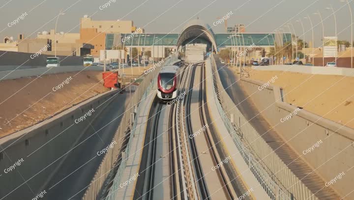 A metro train rides to a modern station in the city of Riyadh