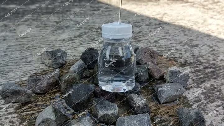 A small bottle with a white lid containing mineral water or Zam Zam water