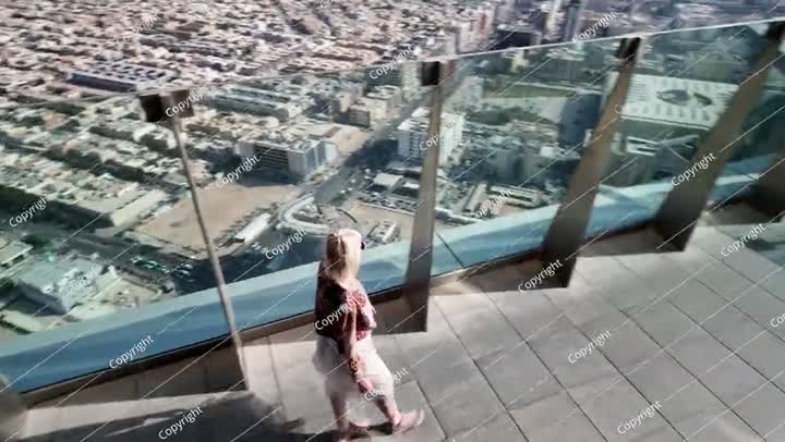 Tourist enjoying panoramic view of Riyadh from rooftop