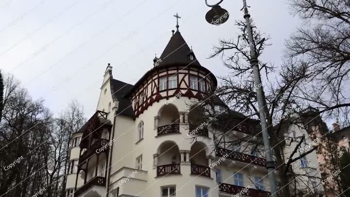 A stunning historic building with a turret and intricate wooden balconies showca