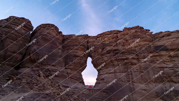 Time lapse of morning sunrise, camping tent at bottle shape rock in Alula
