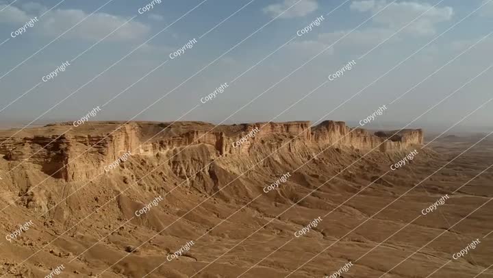 Camera drone flies along the ridge of Jabal Tuwaiq