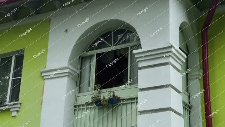 Window of an old house with a flowerbed on the windowsill