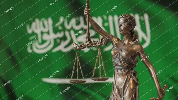Lady Justice statue with Saudi Arabia flag as background.