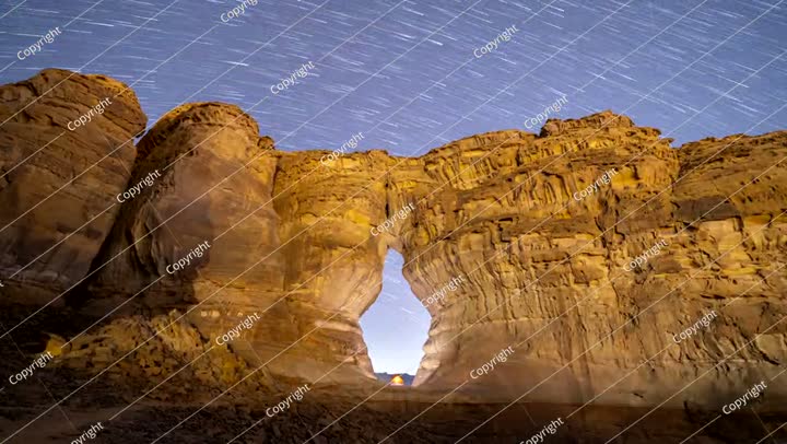 Time lapse of night stars motion at bottle shape rock , Saudi Arabia