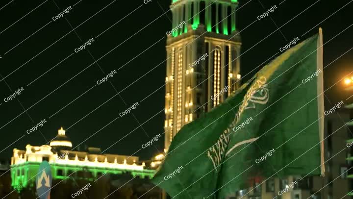 Saudi Flag Waving at Night During National Day Celebration