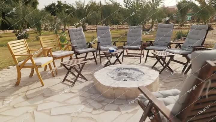Outdoor Fire Pit Lounge in a Palm Oasis. Saudi Arabia. Video.