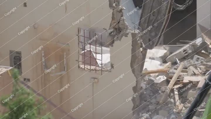 Demolition of residential building in Saudi Arabia Excavator loads and moves