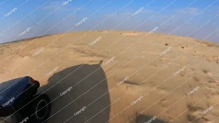 Off road vehicle exploring the sandy dunes of Al-Asfar lake in Saudi Arabia