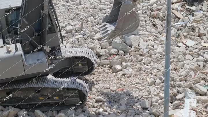 Demolition of residential building in Saudi Arabia Excavator loads and moves