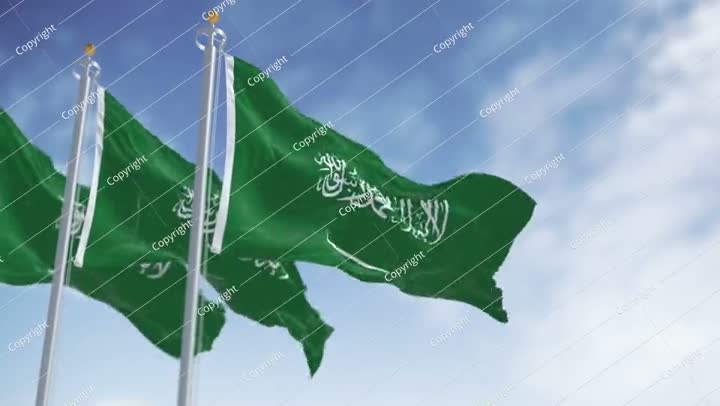 Saudi Arabian flags waving in the wind with national emblem and green field