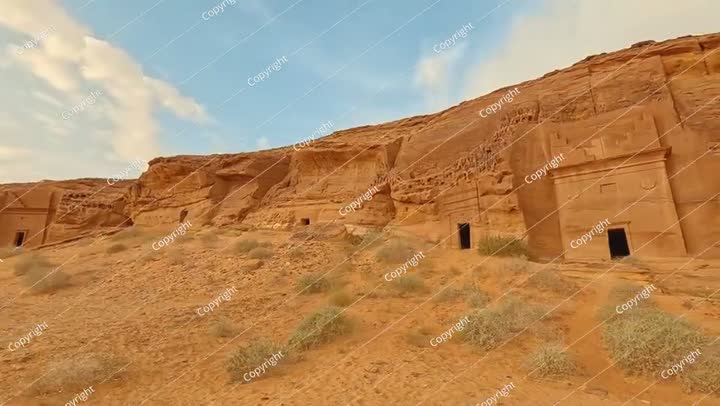 Old Nabatean architecture carved on orange sandstone wall at Jabal Al Ahmar..