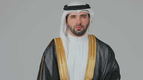 مفهوم الهيبة والرجولة والاهتمام بالمظهر الخارجي، تأسيس الاتحاد 2 ديسمبر، التأمل والتجول في الامارات العربية المتحدة، استذكار اليوم الوطني الاماراتي 1971 م، حب الوطن والاعتزاز به، رجل عربي خليجي إماراتي يرتدي الكندورة والبشت مع الغترة يقف بثقة واستقامة، خلفية بيضاء