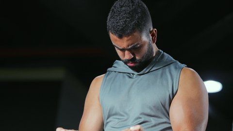 A healthy lifestyle, a hobby of weightlifting, following a healthy diet, physical activity to maintain physical health, a young Saudi Arabian man from the Gulf exercising with a barbell, bodybuilding, gestures of strength and confidence